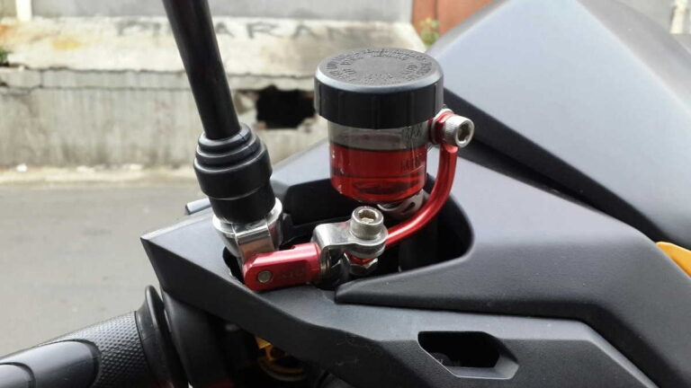 Reservoir minyak rem motor dengan level di bawah garis minimum